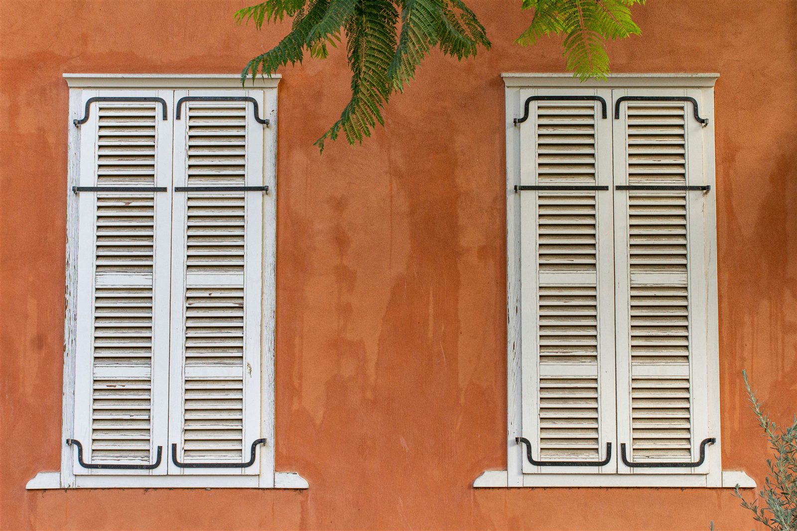 Façade de maison enduite avec volets anciens